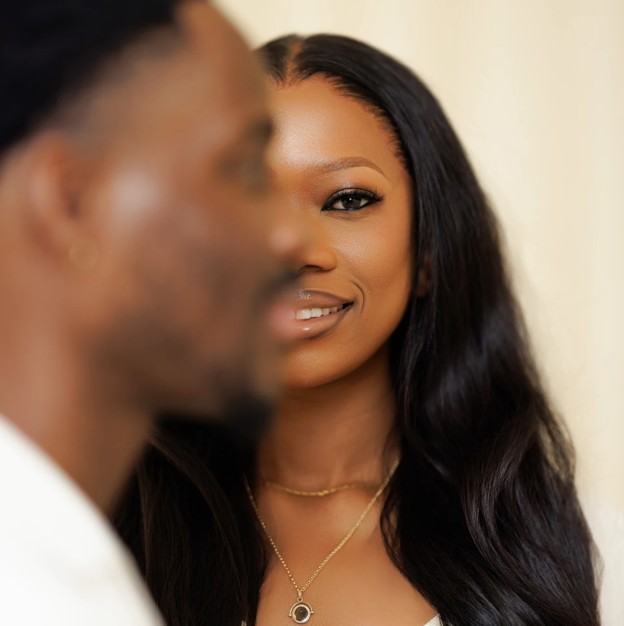 Couple close together, the woman smiling toward the camera in soft light, edited with the Vine presets